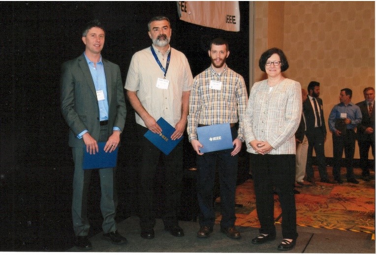 Figure 2: Dr. Matthew Gadlage, pictured on the left, receiving an award at an IEEE event, which is a worldwide organization for engineering, computing, and technology information. 